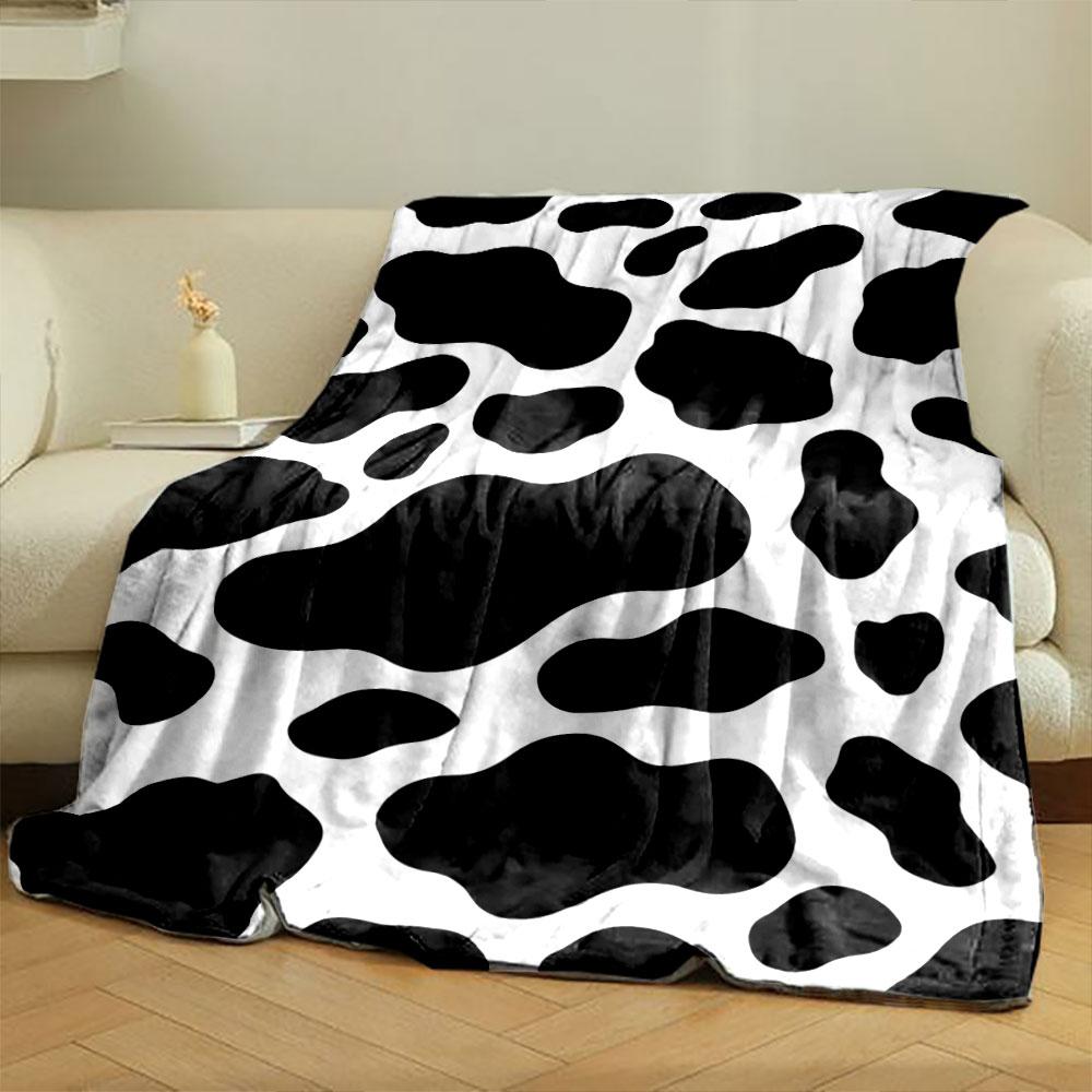 Black irregular spots on a white background resembling a cow print. for all seasons blanket lunch break throw gift