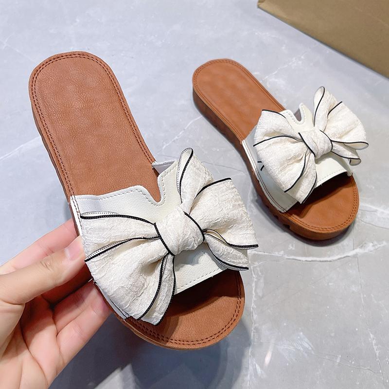 2024Крутые тапочки для женщин, носящих летние универсальные пляжные туфли с бантом и подошвой из сухожилий с плоской подошвой и нескользящие шлепанцы
