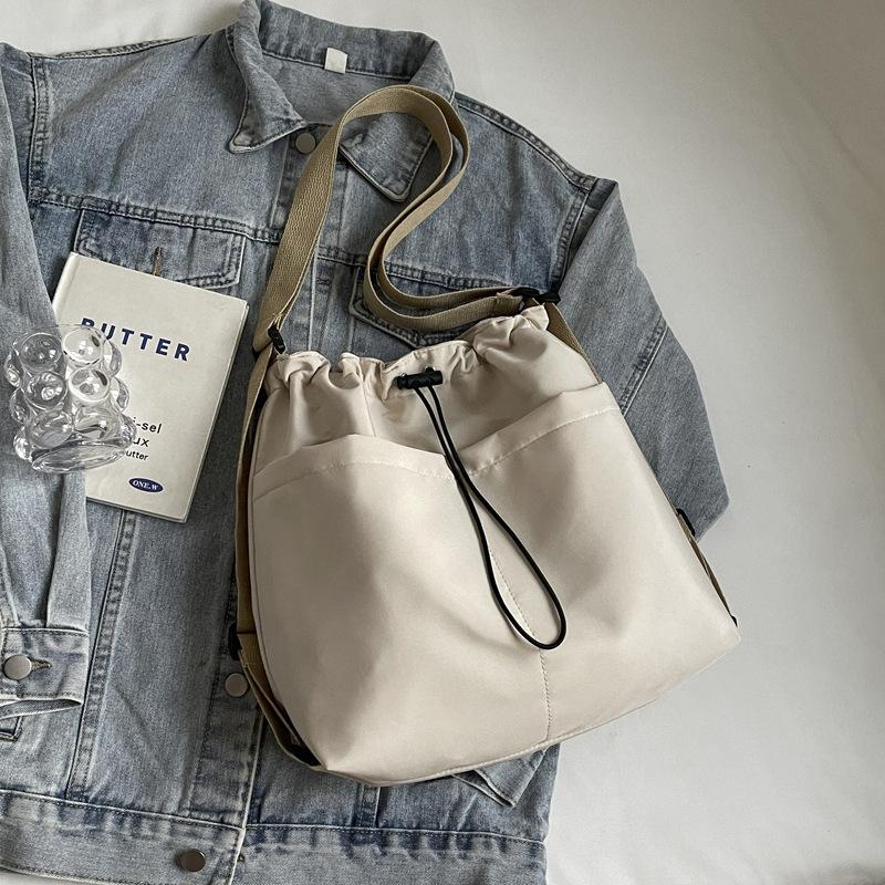 2024 New Japanese Solid Color One Shoulder Underarm Bag Folded Simple Drawstring Lightweight Casual Commuter Double Shoulder Bucket Bag
