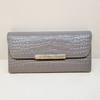 A soft, slim women's long wallet with a subtle pattern.
