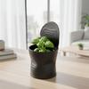 Black flowerpot in the shape of a crushed plant can, modern design