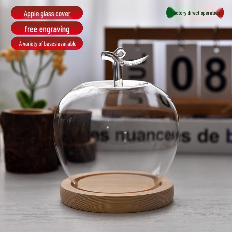 Купол из стекла с изображением вареных яблок и цветов, украшенный глиняной поделкой, для украшения рождественского стола.