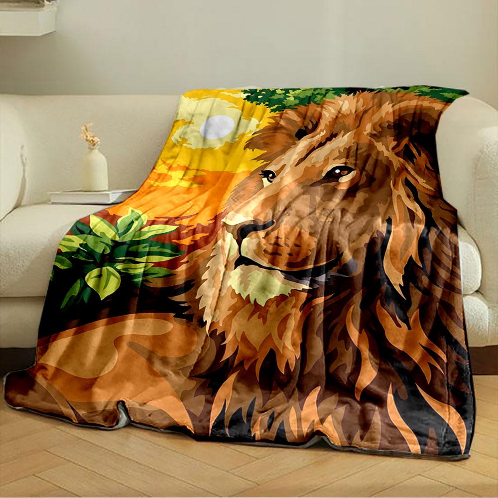 A majestic lion with a vibrant orange sunset and green foliage background. for all seasons blanket lunch break throw gift