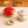 Stylish, heat-resistant straw trivet with hooks, perfect for iron kettles, pots, earthenware pots, and other ironware. A simple, decorative accessory