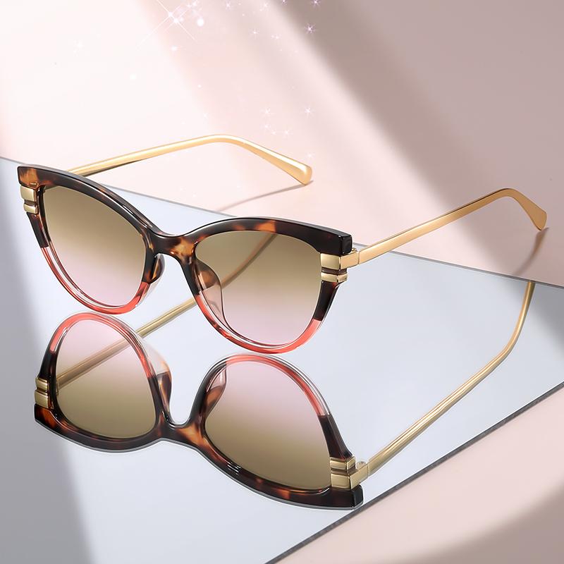 New Fashion Cat Eye Sunglasses with Black Top Frame, Red Patterned Lower Frame, Gold Metal Arms, and Gradient Brown Lenses for