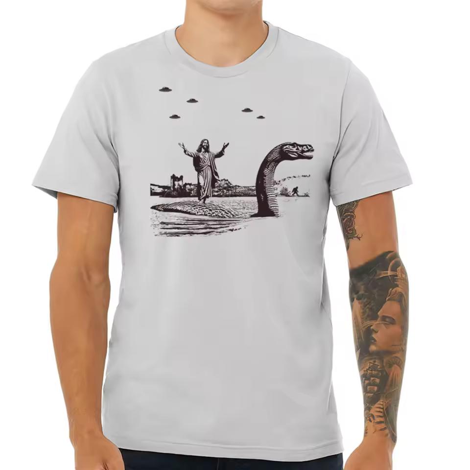 Esus Christ Riding The Loch Ness Monster Men's Tshirt Guys Funny Dinosaur Tee Humorous Religious Tee with Jesus and Nessie Tee