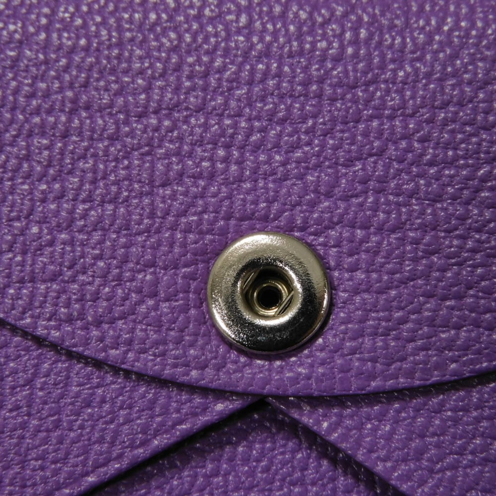 Used 9212 Calvi 7946 Chevre Mysore goatskin bag with gold-stamped logo and purple snap buttons. Excellent condition.