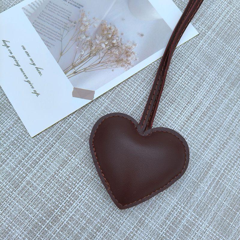 New niche leather peach hand rope pendant simple bag pendant car couple backpack accessories fashion Bag Charm