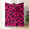 Black irregular shapes resembling leopard spots on a bright pink background. for all seasons blanket lunch break throw gift