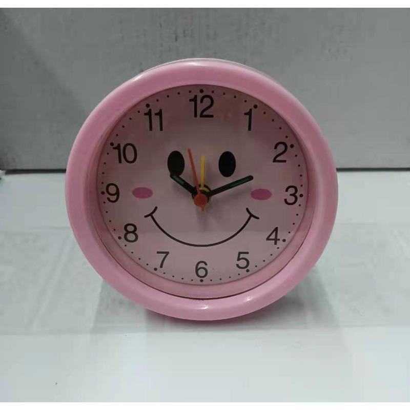 Round, Multiple Smiling Faces and Small Alarm Clock