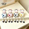 Cow Figurine Resin Statue, Cute Shelf Sitter with Dangling Rope Legs, Garden Decor for Patio Cartoon Farmhouse Animal Ornament Fence Railing, Planter,