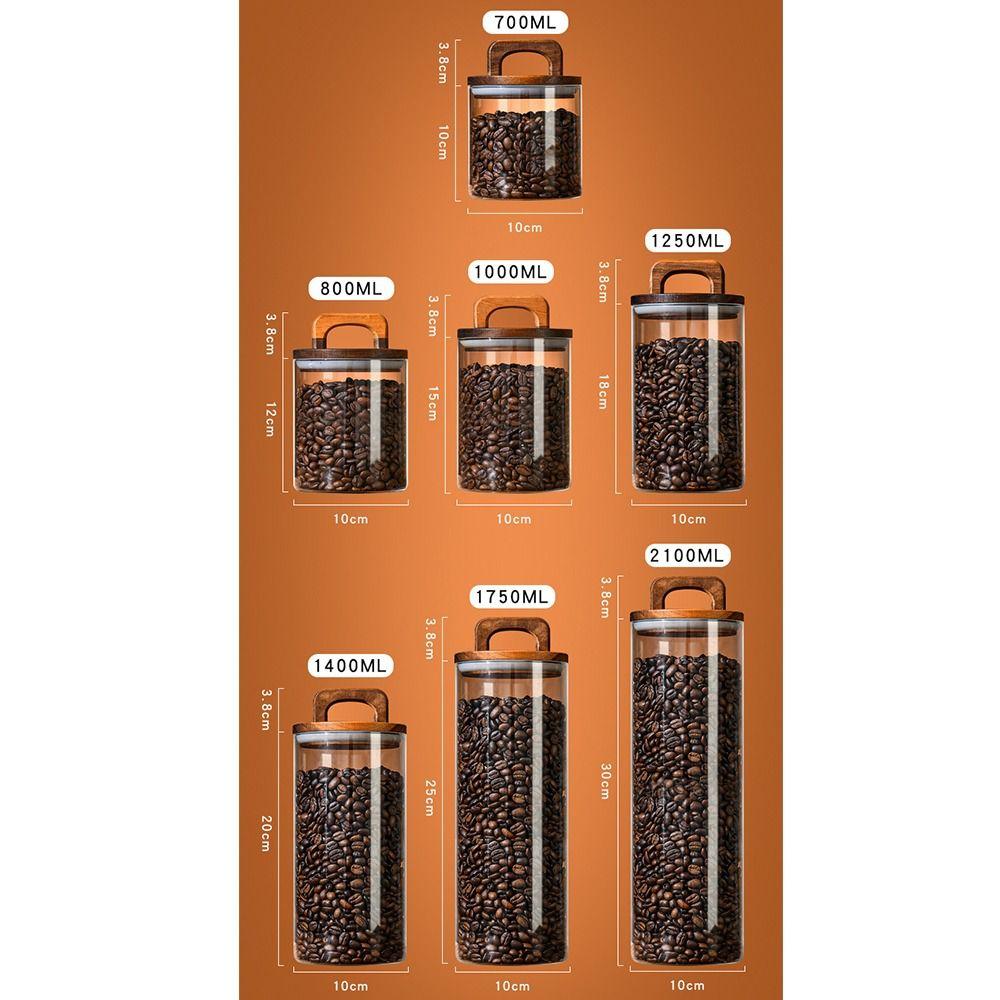 Прозрачные стеклянные банки с деревянной ручкой и крышкой. Банка для хранения. Простые герметичные бутылки. Кухня.