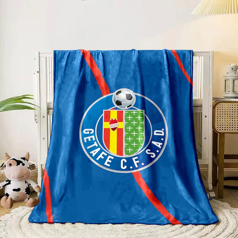A blue background with red diagonal lines and a football club crest. for all seasons blanket lunch break throw gift
