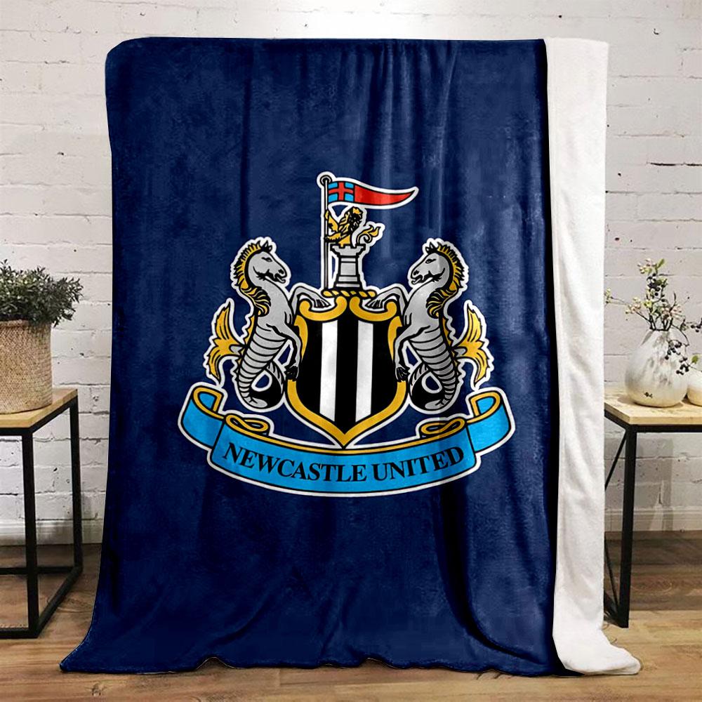 A shield with black and white stripes, flanked by seahorses, and a banner. for all seasons blanket lunch break throw gift