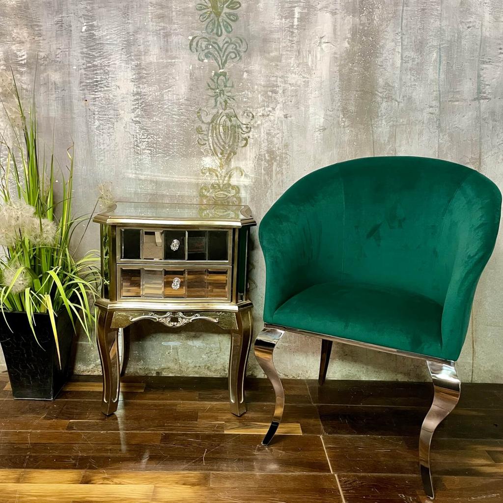 Green velvet living room armchair with silver legs in glamour style