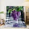 A cluster of water-drenched purple grapes with splashes and ripples below. for all seasons blanket lunch break throw gift