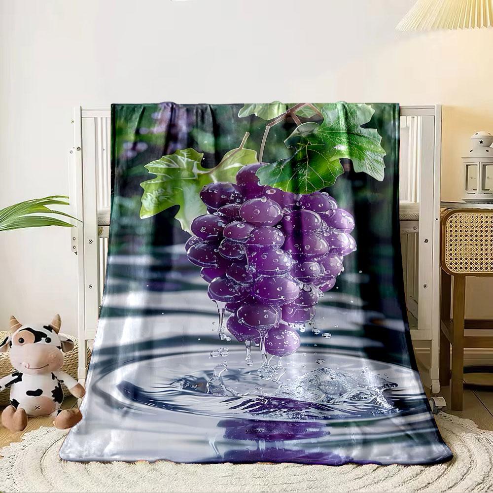 A cluster of water-drenched purple grapes with splashes and ripples below. for all seasons blanket lunch break throw gift