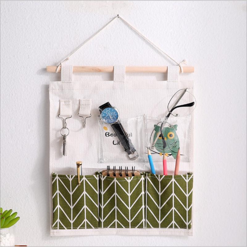 Полосатая настенная подвесная сумка для хранения из хлопка и льна с бантом и множеством карманов для кухни или ванной комнаты.