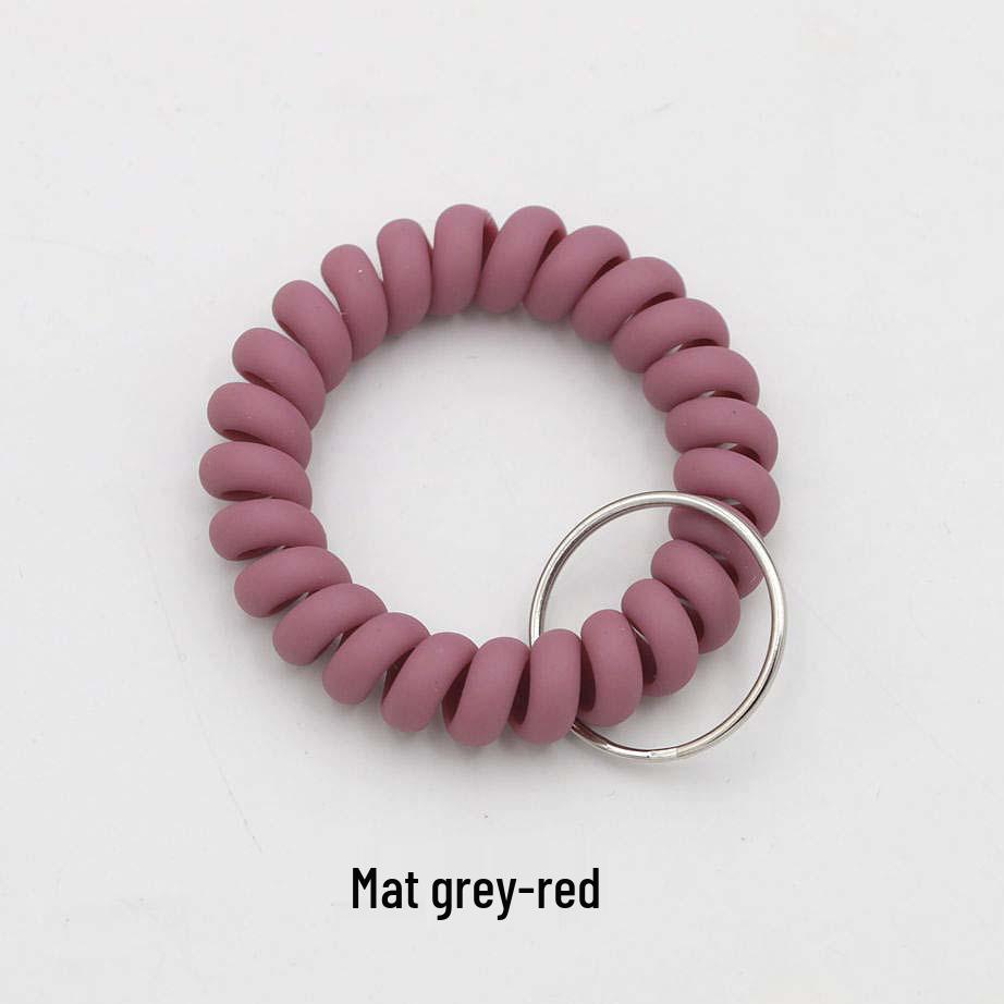 Минималистичный браслет-брелок и резинка для волос в виде пружинного механизма