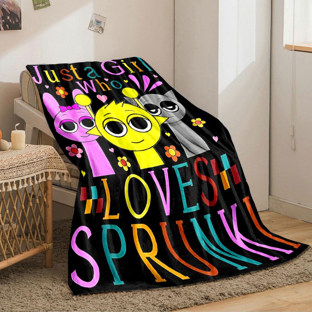 Three cartoon characters with colorful text and flowers on a black background. for all seasons blanket lunch break throw gift