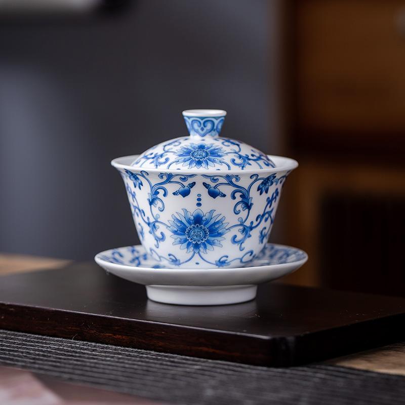Suet jade porcelain blue and white ceramic kung fu tea set enamel color ten thousand flower cover bowl teacup household gift gift box