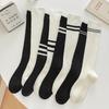 Women's Autumn/Winter Warm Solid Color Cotton Knee High Socks with Double Needle Slimming and Two/Three Stripe Pile Design.