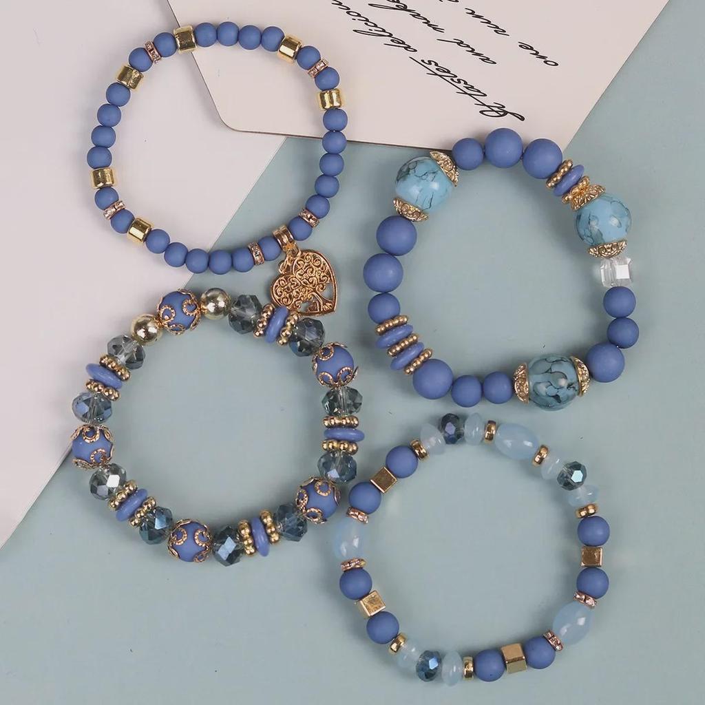 Многослойный браслет-кисточка в богемном стиле с полыми подвесками в форме сердца и стеклянными бусинами.