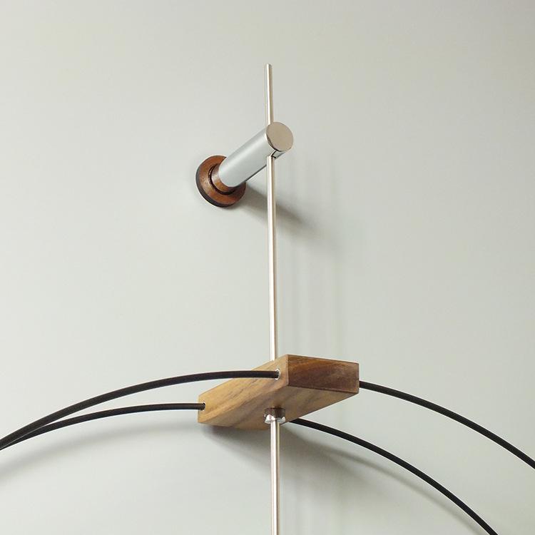 Nordic Modern Minimalist Spanish Nomon Wall Clock, Black Walnut with Large Copper Pointer for Hotel and Living Room Decor.