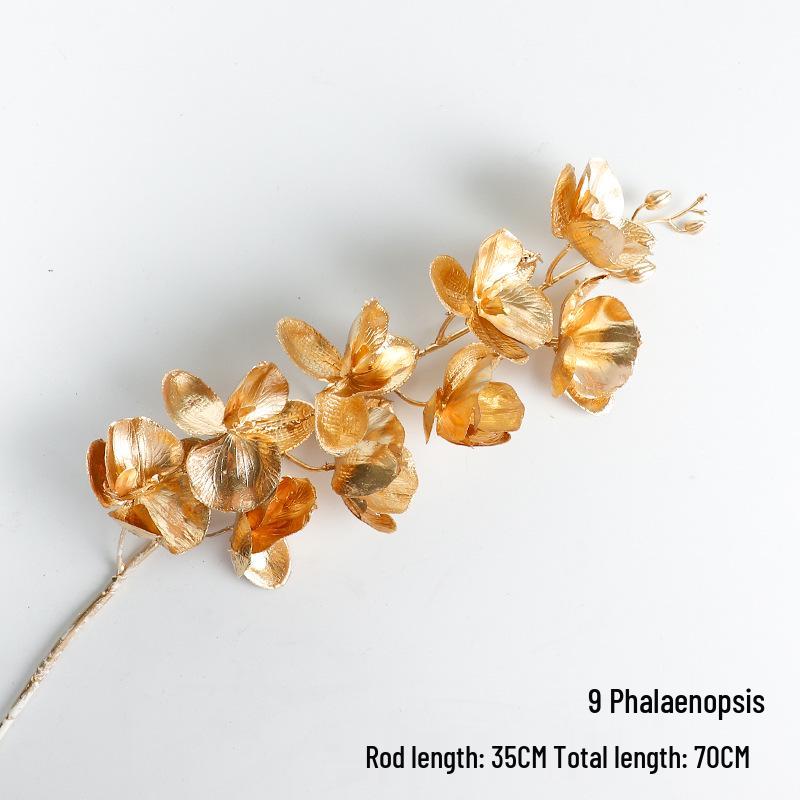 New Year Floral Arrangement with Golden Eucalyptus, Fan Leaf, Simulated Holly, Ginkgo, and Golden Leaf.