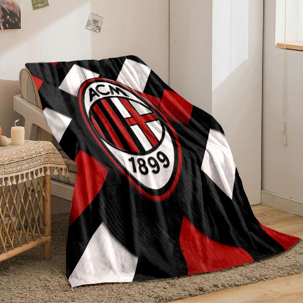 Interwoven red, black, and white strips with an oval emblem in the center. for all seasons blanket lunch break throw gift