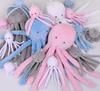 Octopus cuddly toy for children with a rattle - gray