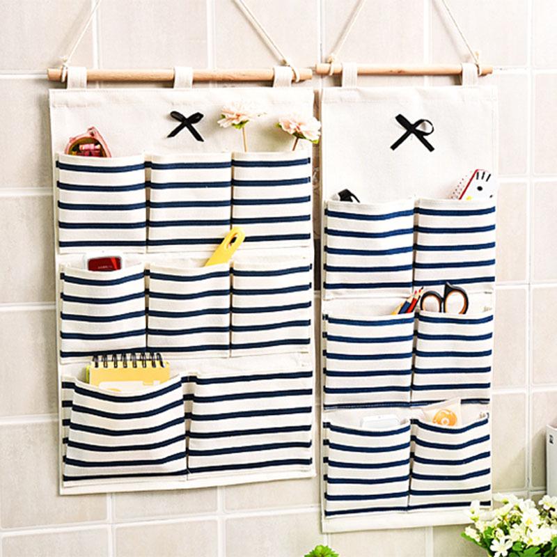 Полосатая настенная подвесная сумка для хранения из хлопка и льна с бантом и множеством карманов для кухни или ванной комнаты.
