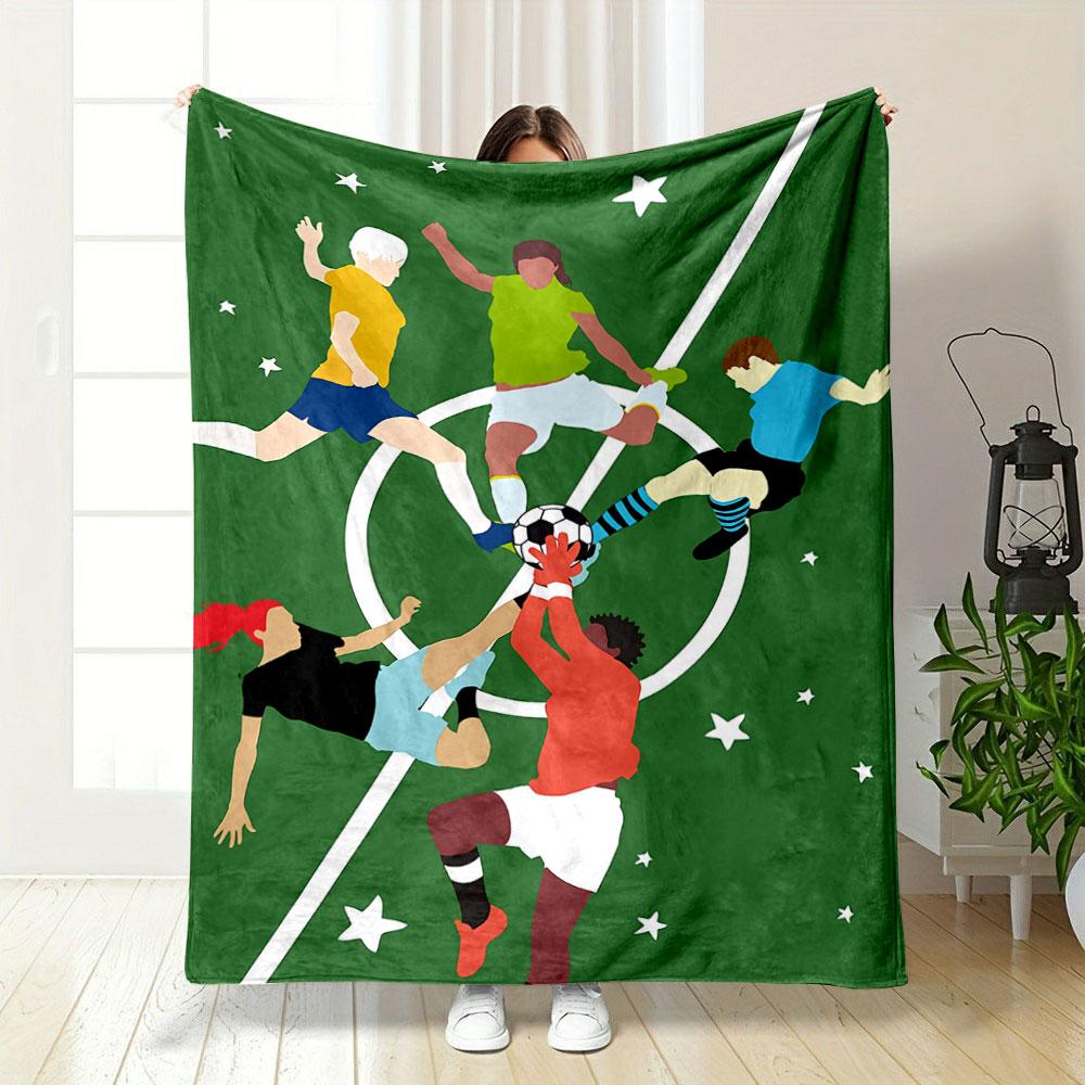 Players contest a soccer ball mid-air on a green field with star motifs. for all seasons blanket lunch break throw gift