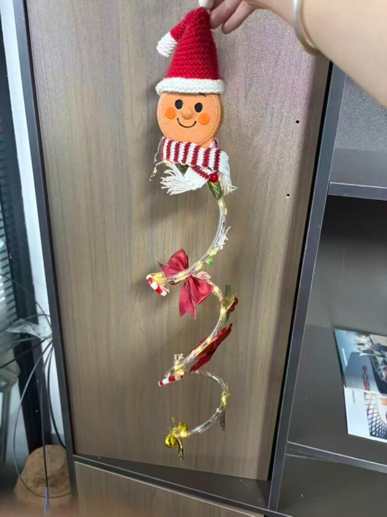 Gingerbread glowing three-dimensional Christmas door decoration in color