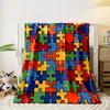 Interlocking colorful puzzle pieces in a random arrangement. for all seasons blanket lunch break throw gift