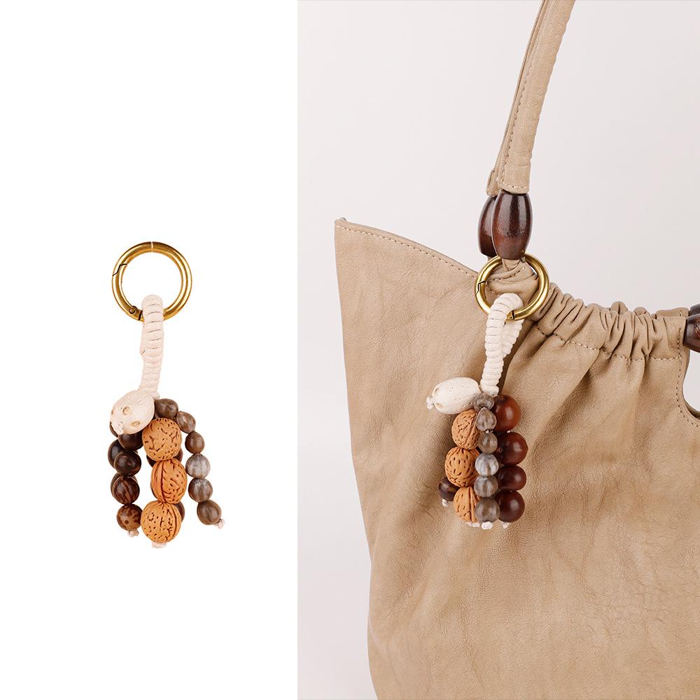 Wish-Fulfilling Bodhi Seed String Bag Charm - Hand-Woven Natural Keychain Ornament with Turquoise.