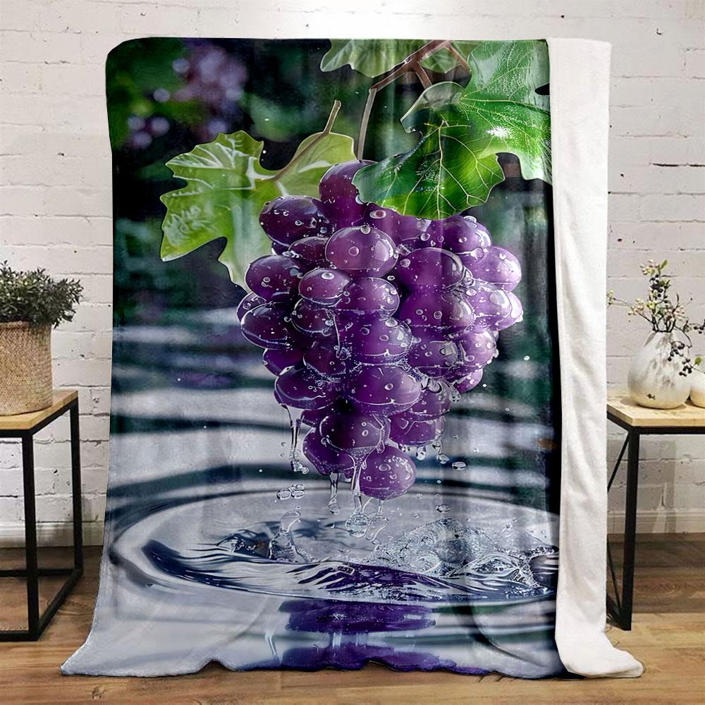 A cluster of water-drenched purple grapes with splashes and ripples below. for all seasons blanket lunch break throw gift