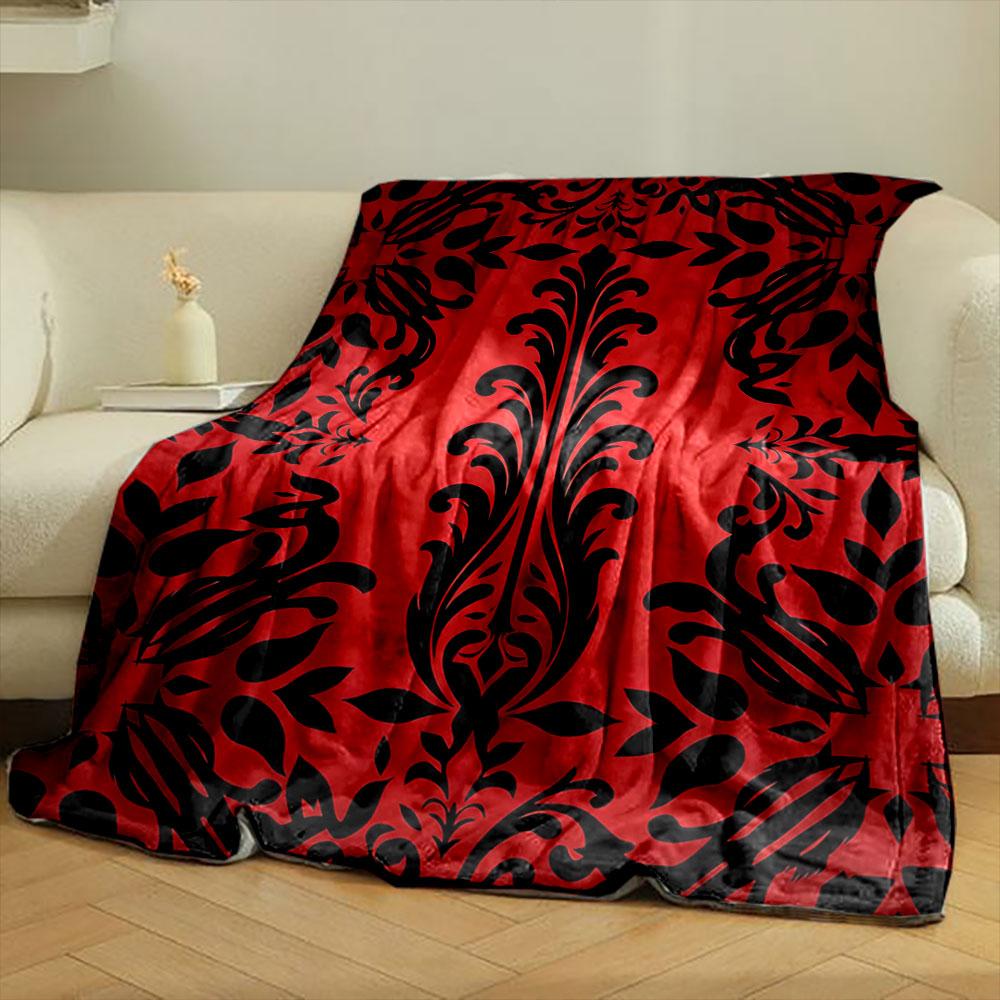 Bold black floral motifs on a red background with symmetrical design. for all seasons blanket lunch break throw gift