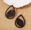 Niche design retro artistic earrings, laser-cut wood-cut hollowed-out water drop rugby shaped ear hooks