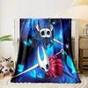 Two horned characters with sharp weapons, surrounded by glowing blue shapes. for all seasons blanket lunch break throw gift