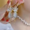 New Zircon Flower Long Tassel Ball Ear Buckle Earrings Women's Long Cat's Eye Stone Design Sense Versatile Earrings