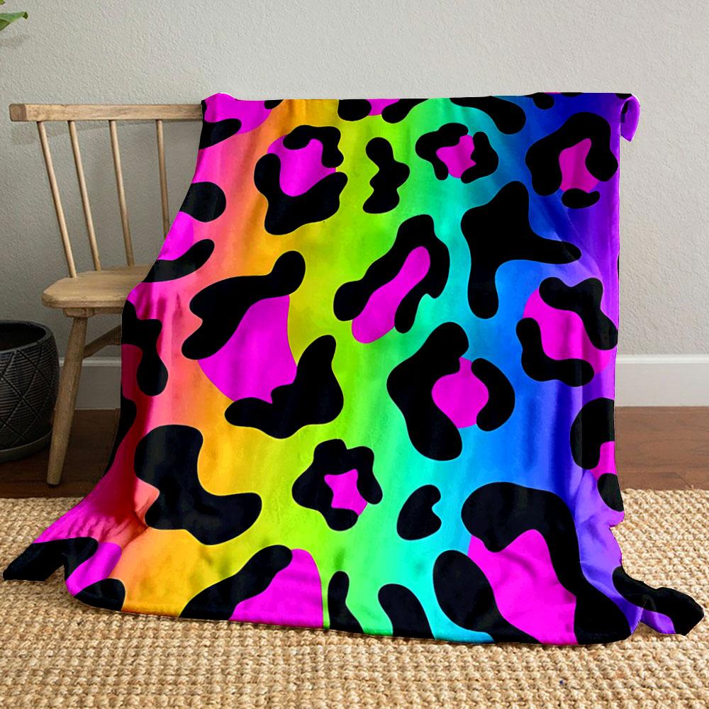 Leopard-like spots with black shapes on a vibrant rainbow gradient background. for all seasons blanket lunch break throw gift