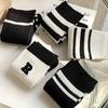 5 pairs of fashionable black and white mid tube socks, unisex, with black and white striped design