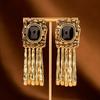 Pre-owned Black Gold Tassel Earrings with Woven Texture and Black Gemstone Embellishment.