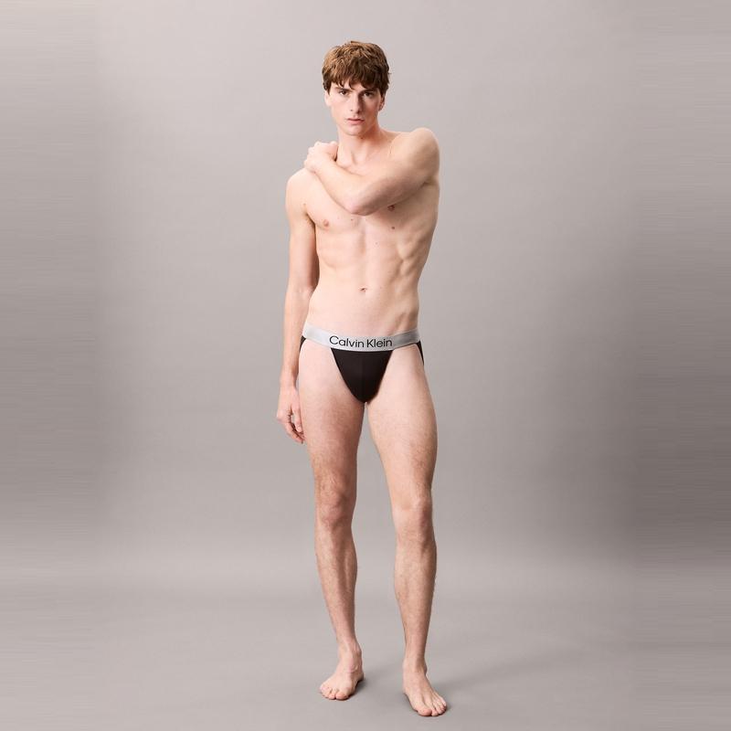 Calvin Klein Блестящее полупрозрачное нижнее белье-стринги с двойным ремешком Shiny Gravity для мужчин, нижнее белье, космически-черный цвет, NB4125-UB1