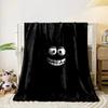 A glowing, cartoonish face with wide eyes and a big toothy grin on black. for all seasons blanket lunch break throw gift