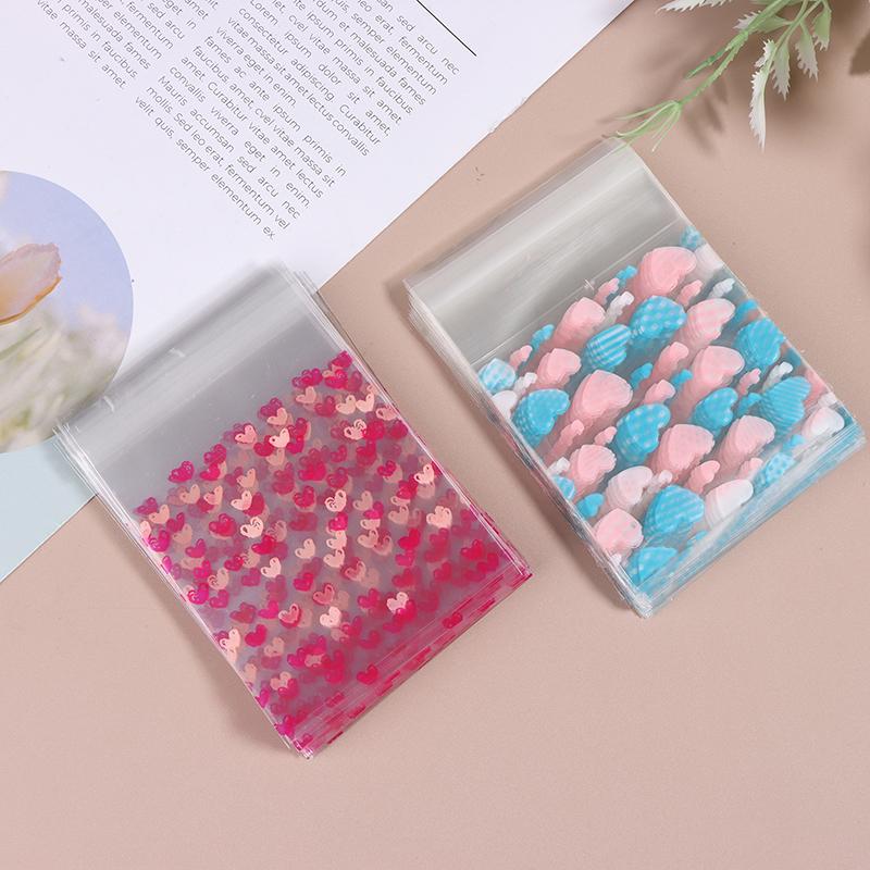 100 шт., прозрачный мешок для конфет в форме сердца, пластиковый пакет для печенья и закусок, упаковка для украшения выпечки, самоклеящаяся сумка