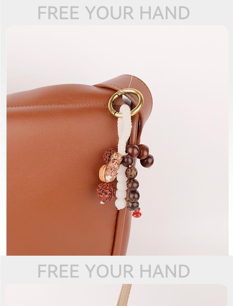 Wish-Fulfilling Bodhi Seed String Bag Charm - Hand-Woven Natural Keychain Ornament with Turquoise.