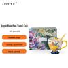 yellow hand-painted ceramic mug with spoon