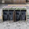 Trash can box, horizontal wood-grain panels, trash storage compartments, lockable, four doors, planting area, diamond-shaped hollow door panel